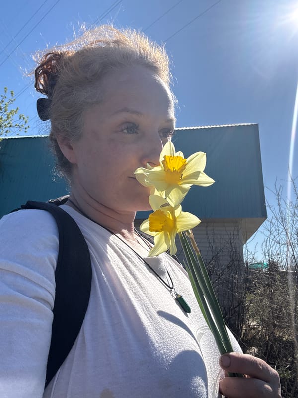 Woman documents spring day with dog and daffodils in Chaikovsky