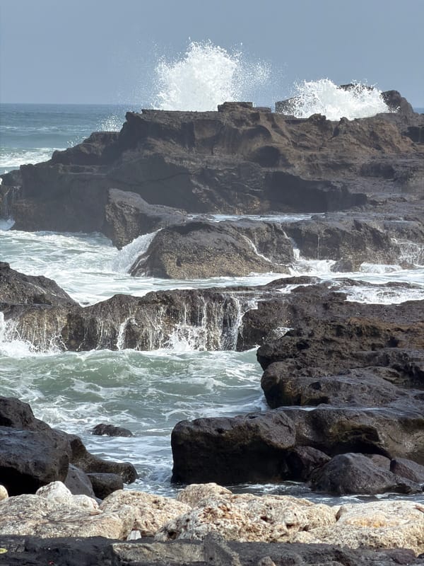 Clifftop cafe and rocky shoreline on Bali's coast