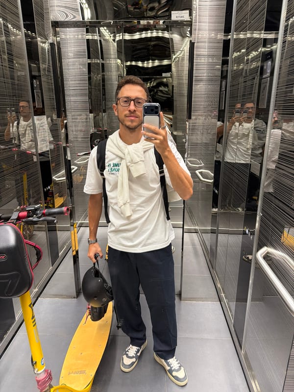 Man takes elevator selfie with yellow scooter and helmet
