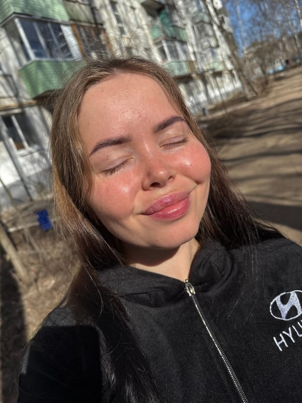 Woman rests outdoors in morning sunlight in Izhevsk