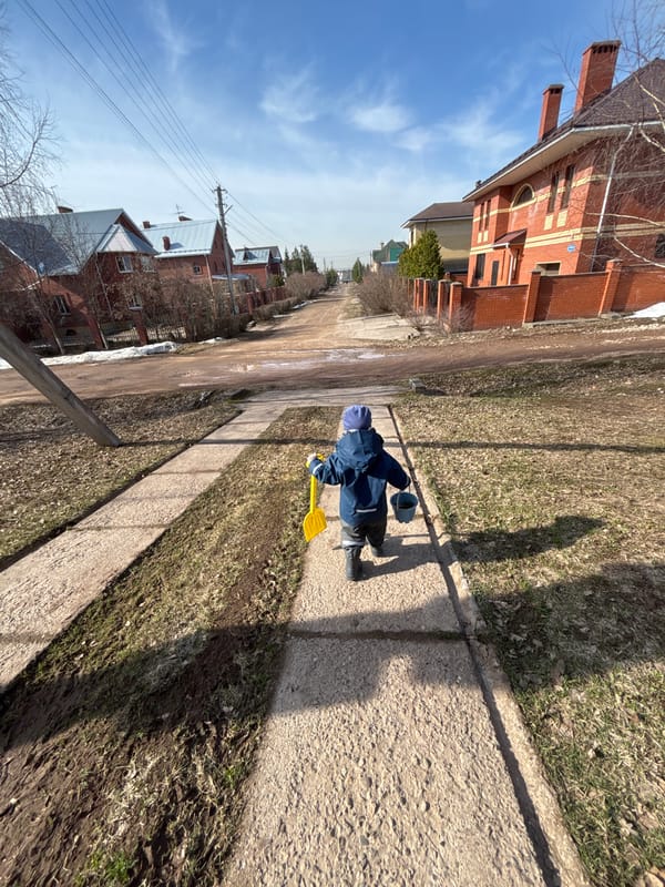 Child plays with toys on village streets in Russia