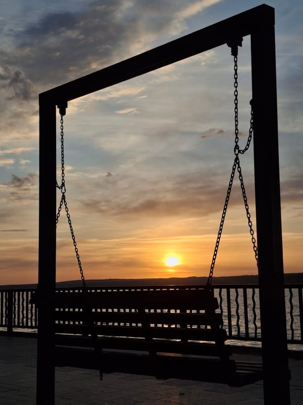 Woman enjoys sunset swing moment in Chaikovsky, Russia