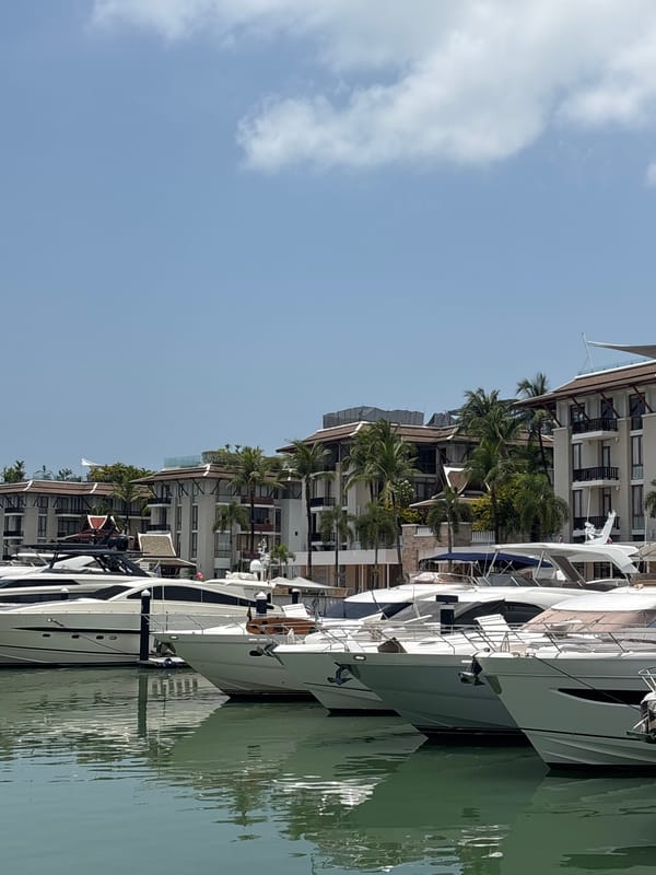 Woman enjoys morning coffee at waterfront cafe in Ko Kaeo