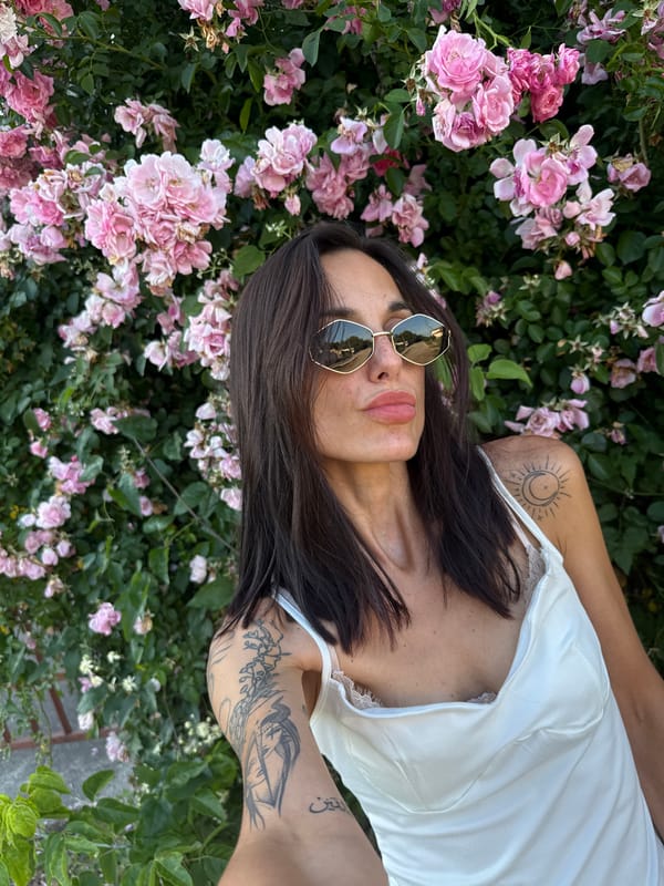Woman takes selfie among pink flowers in Pleven