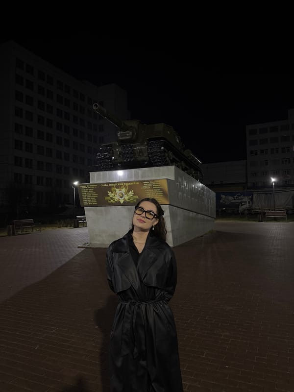 Woman poses at Soviet tank monument in Chaikovsky, Russia