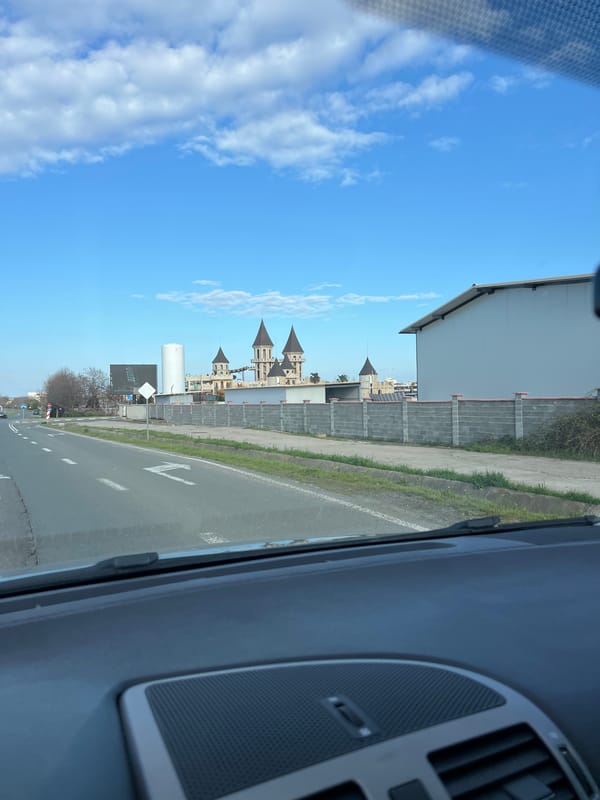 Vehicle passes castle-themed architecture in Ravda, Bulgaria