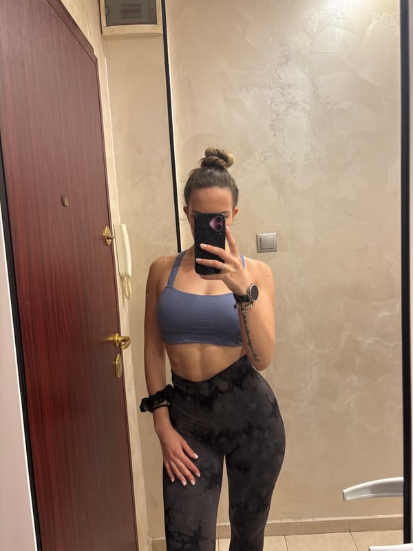 Woman Takes Mirror Selfie in Athletic Wear
