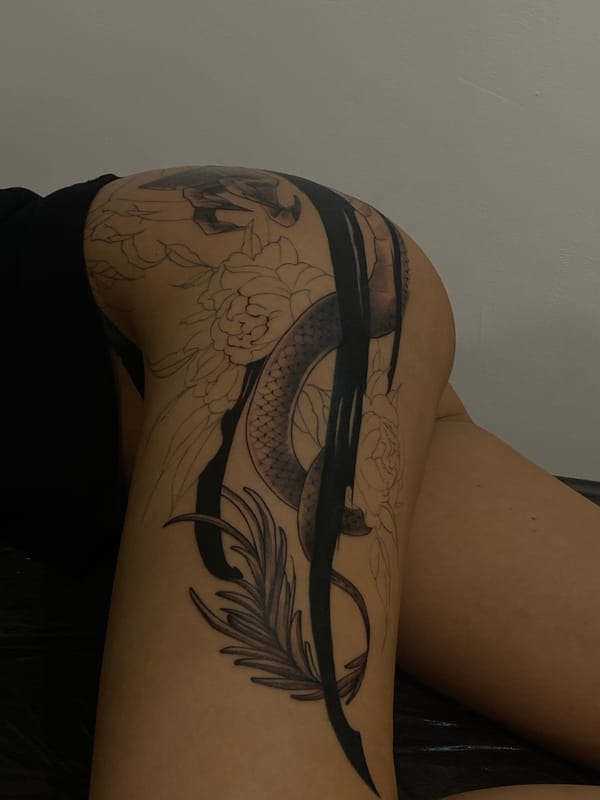 Person displays snake and floral tattoo in Moscow