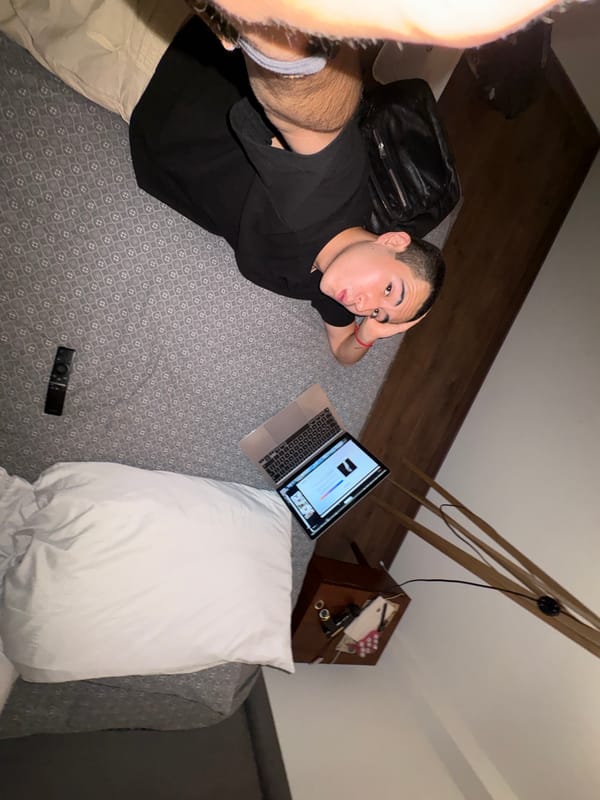 Person rests with laptop in bedroom, Mexico