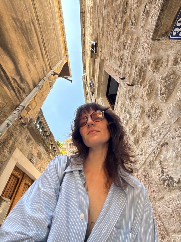 Woman explores historic Kotor fortifications and cobblestone streets