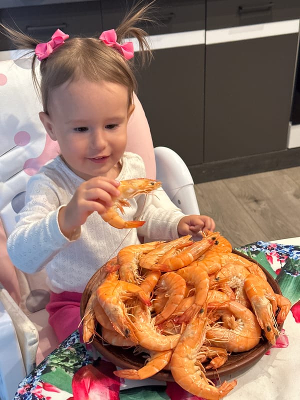 Young girl enjoys shrimp meal, poses in witch costume in Wisła