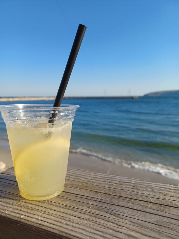 Beverage in plastic cup spotted on wooden surface