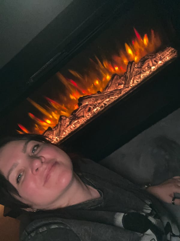 Family gathering around electric fireplace documented in Perm