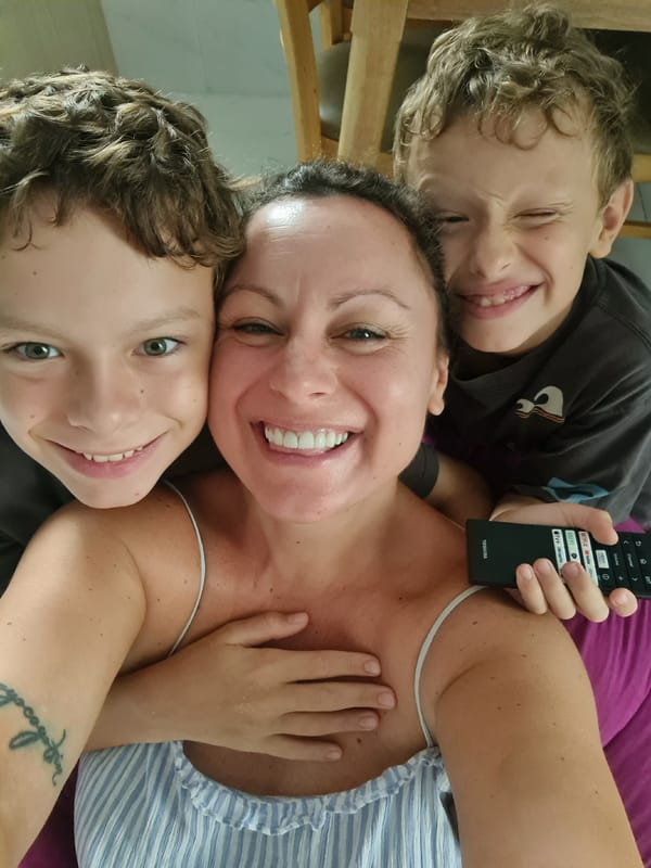 Woman with TV remote photographed with two boys in Vietnam