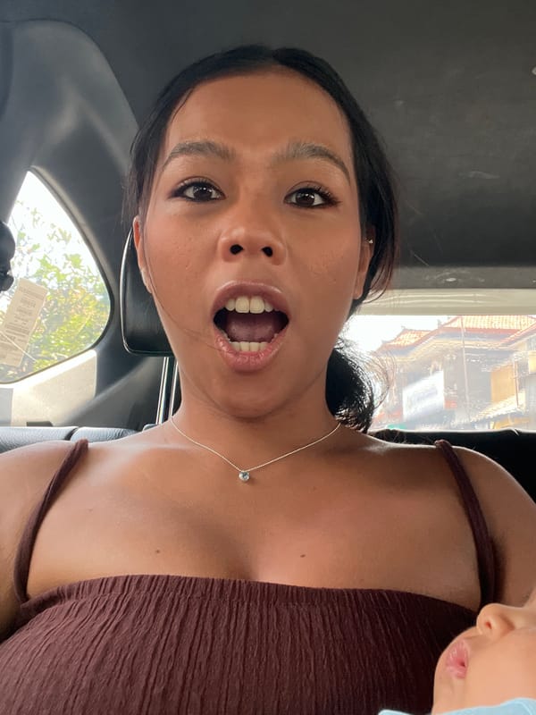 Passengers take selfies during early morning car ride in Kuta