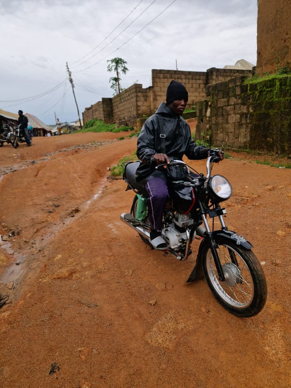 Morning street life across a Jos, Nigeria neighborhood