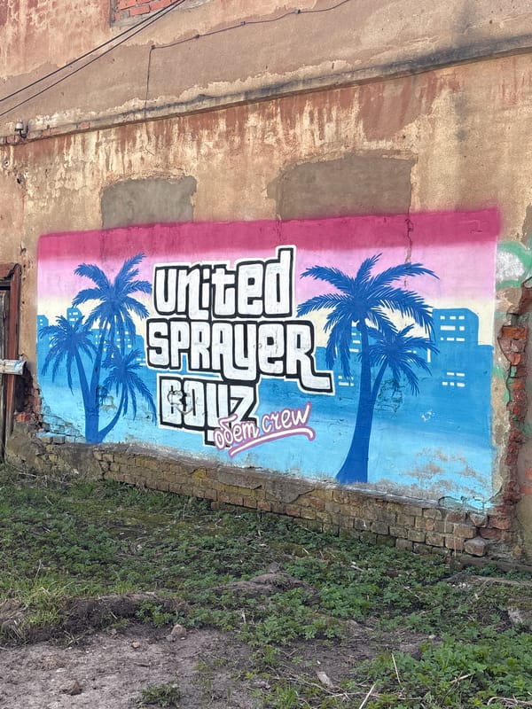 Gradient graffiti mural spotted on weathered wall in Vysokovsk