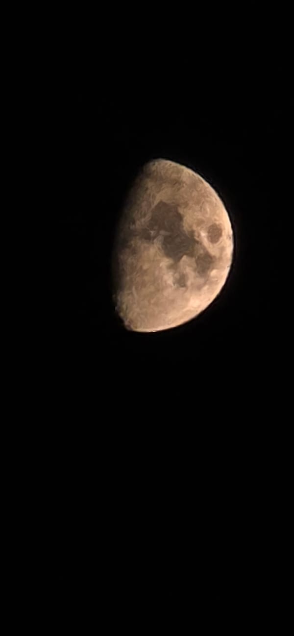Partial moon with visible surface detail, shot from Tivat