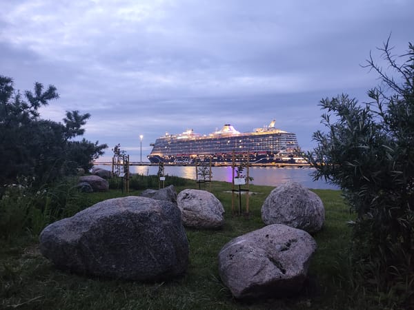 Cruise ships and ferries light up Tallinn harbor at dusk