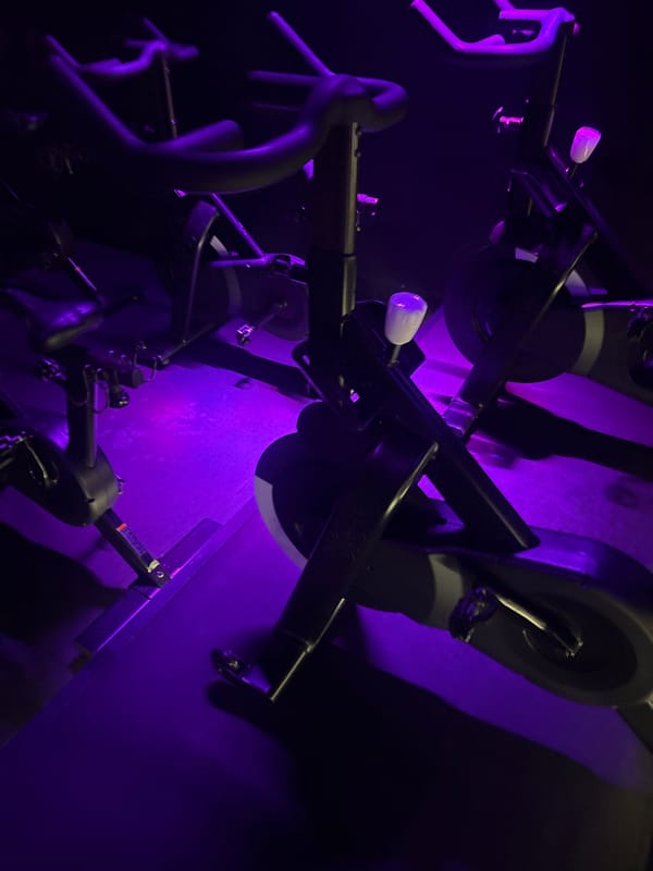 Late-night spin class held in purple-lit Mexico City studio