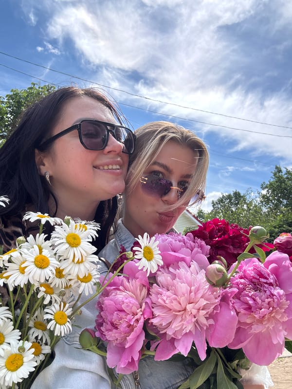 Women visit Orthodox church with peony bouquets during morning outing