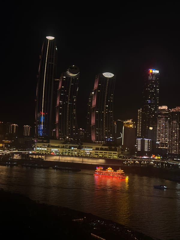 Chongqing riverfront buzzes at night across Yuzhong and Jiangbei