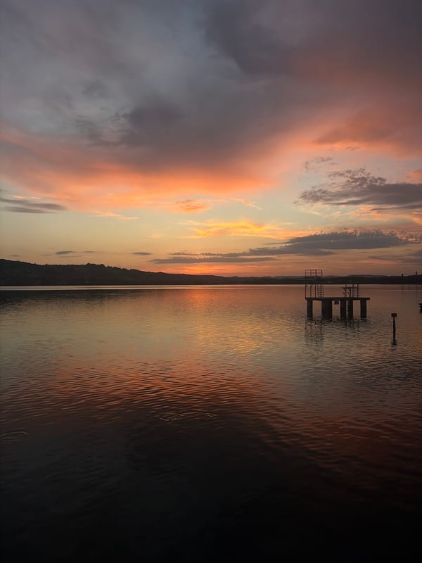 Golden hour at a Swiss lake, pier-side and in the water