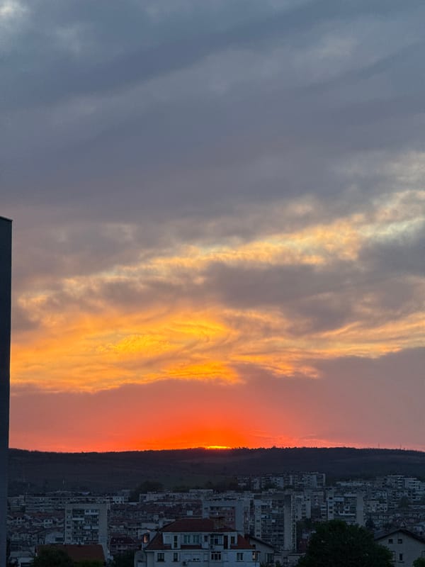 Sunset captured over apartment-covered hills in Pleven, Bulgaria