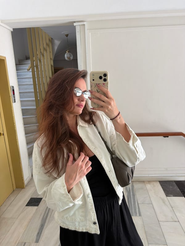 Woman enjoys balcony dining and selfies in Glifada, Greece