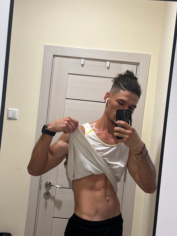 Post-workout mirror selfies in a yellow-walled room