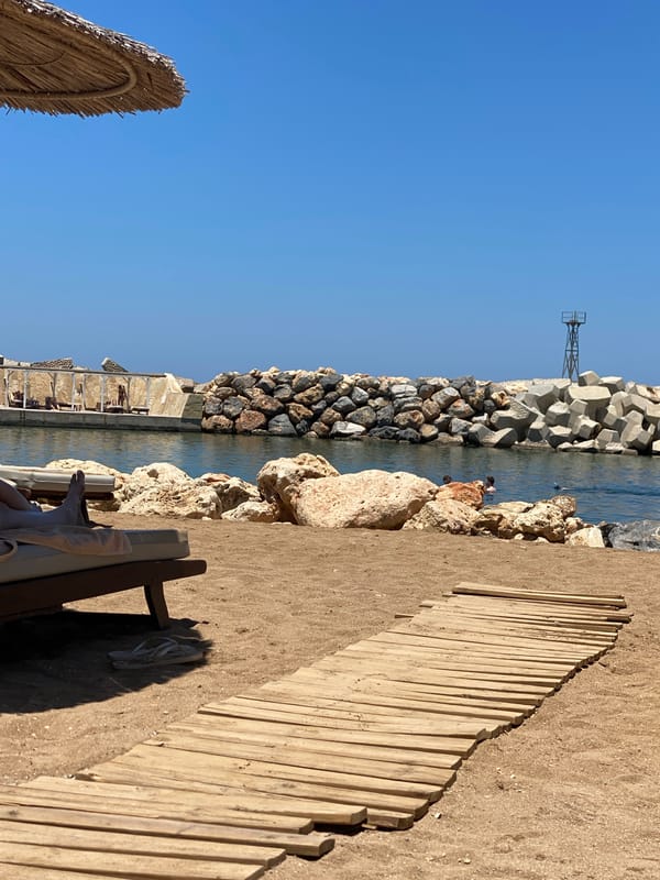 Sunny day on the wooden boardwalk at Panormos beach