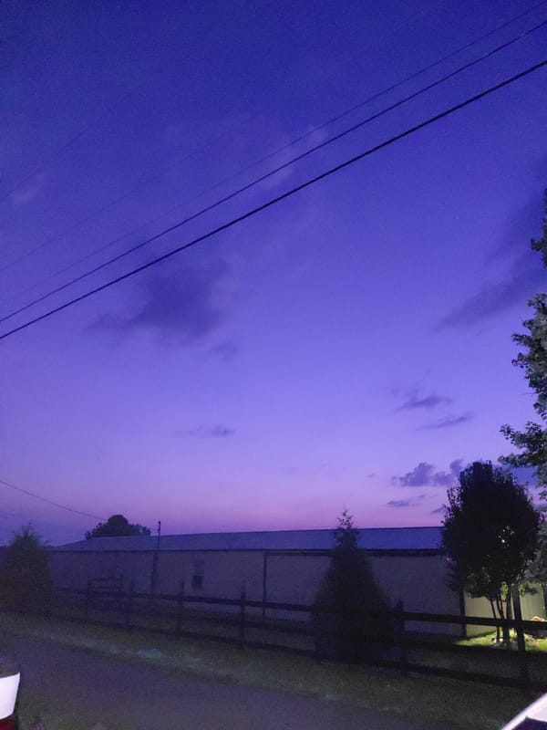 Twilight settles over a flat-roofed building in Richmond, Kentucky