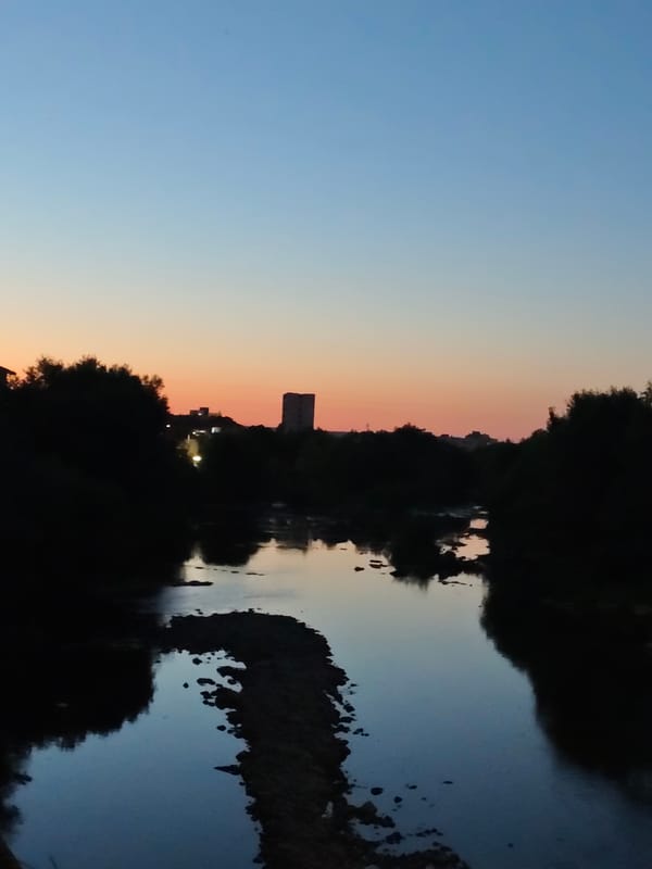 Lovech's riverfront bridges and skyline at dusk