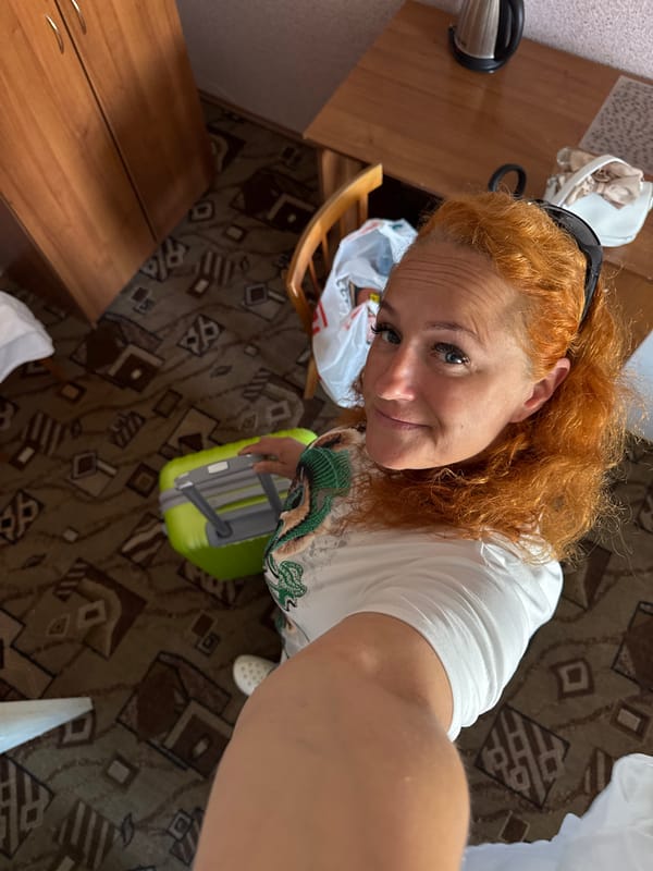 Checking out of a Kazan hotel, green suitcase in tow