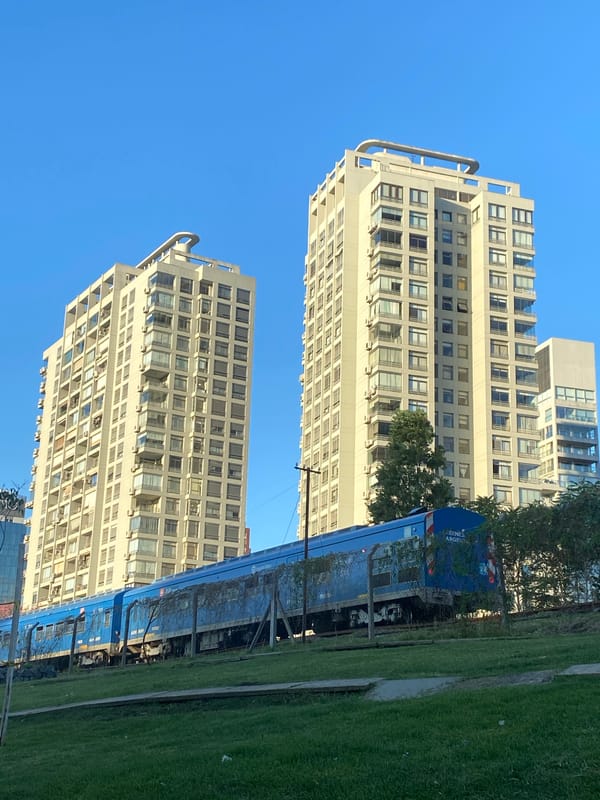 Public train passes through Buenos Aires residential area