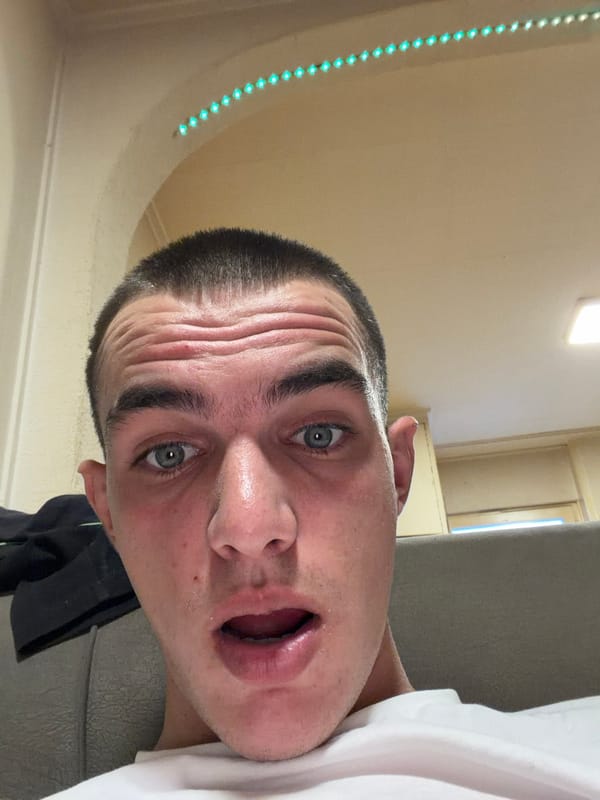 Man takes surprised selfie indoors in Lachen, Switzerland