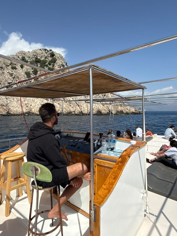 Boat tours Turkish coastline amid rocky cliffs and islands