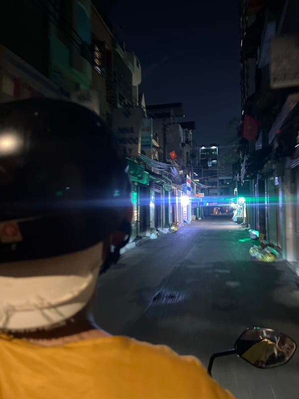 Nighttime motorbike journey documented on Thủ Đức street
