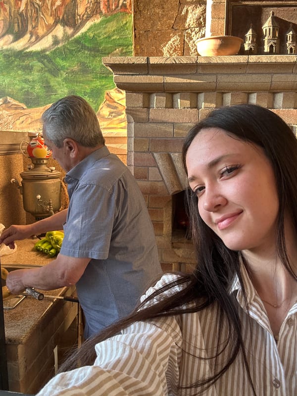Gathering around a brick fireplace at a rustic Yerevan restaurant