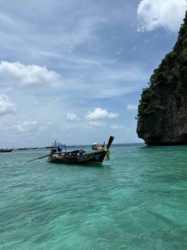 Boat traffic through Ao Nang's limestone cliff channels