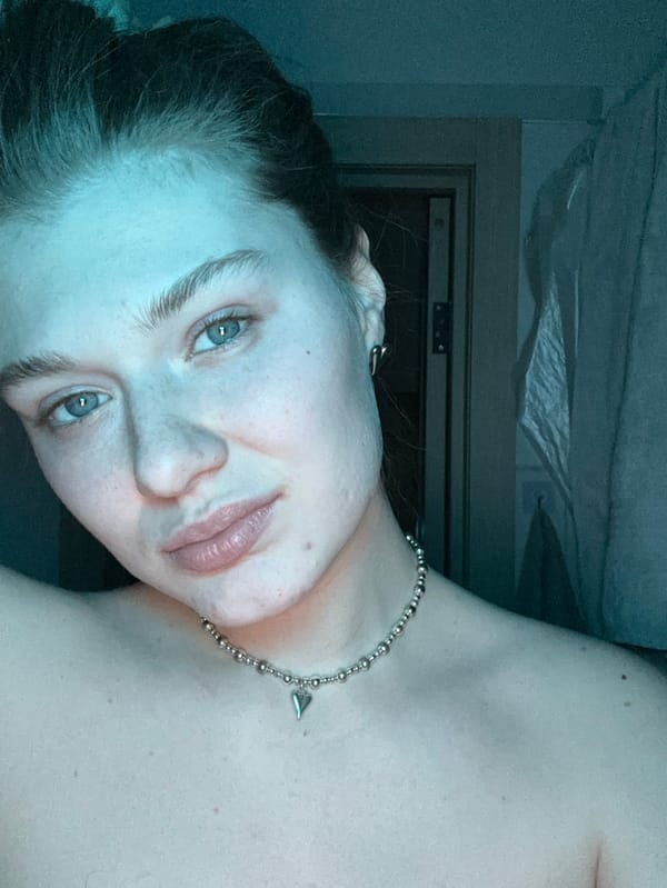 Woman photographed in red-lit indoor sessions in Noviy, Russia