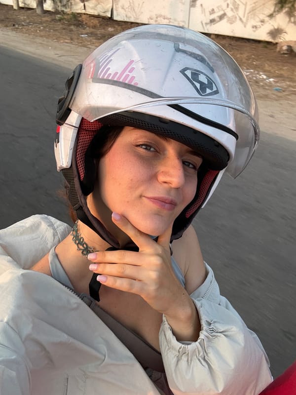 Woman in motorcycle helmet takes selfie in Mũi Né