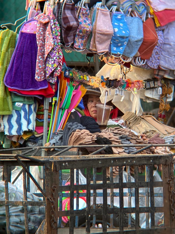 Nha Trang street market buzzes with vendors and scooters at sunset