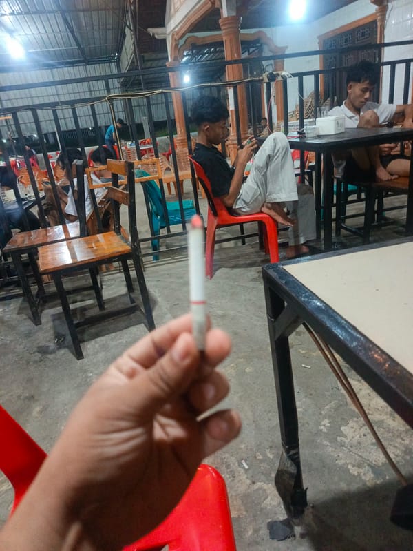 Young men gather at Lhokseumawe cafe for coffee and cigarettes