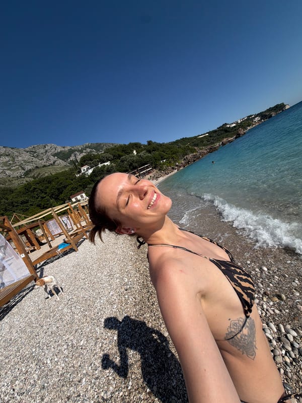 Woman sunbathes on Reževići beach in Montenegro