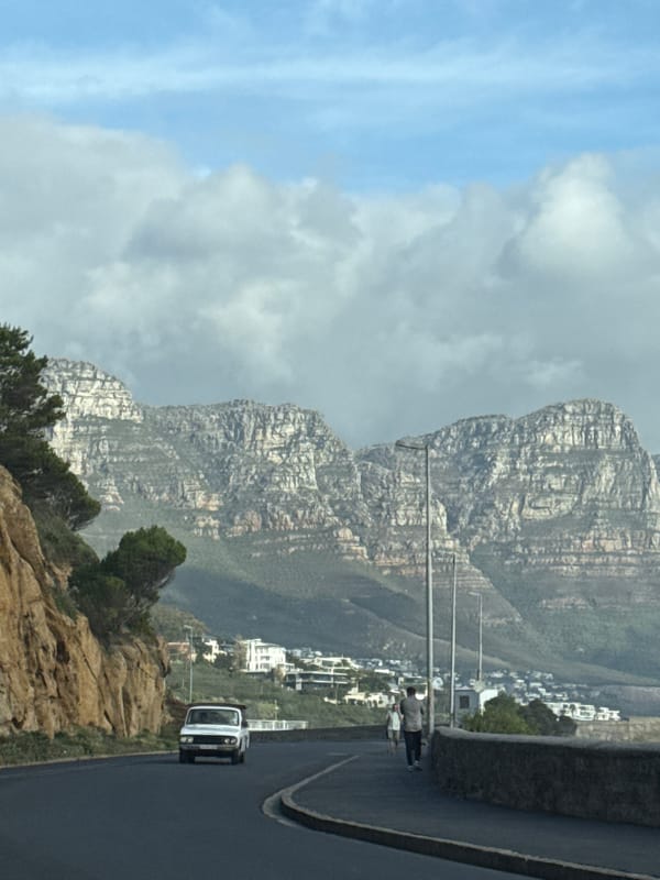 Cape Town roadside views feature cloud-shrouded Table Mountain