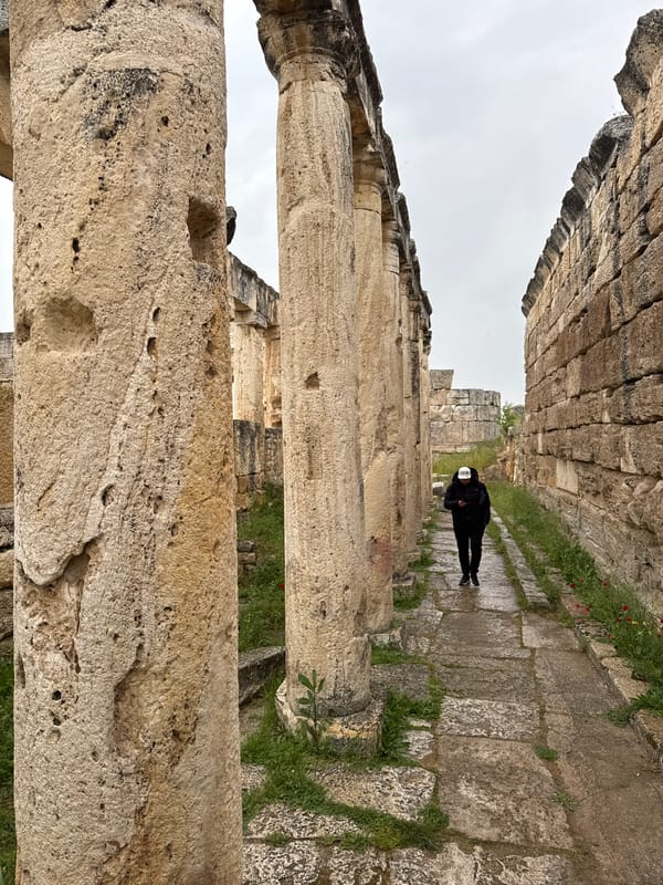 Tourist documents ancient Hierapolis ruins during afternoon visit to Pamukkale