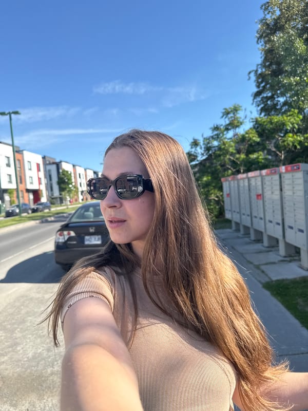Person takes sunny afternoon selfies in Gatineau street scene