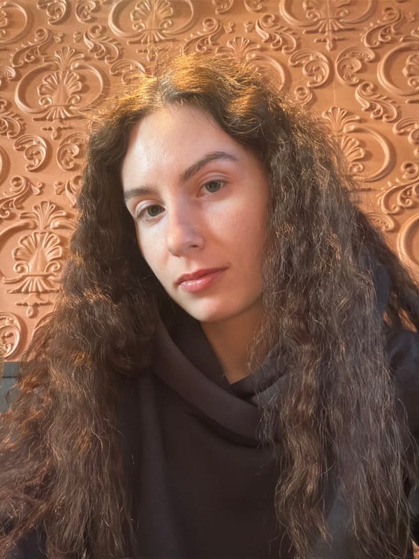 Woman takes selfies against ornate wall in Kudrovo