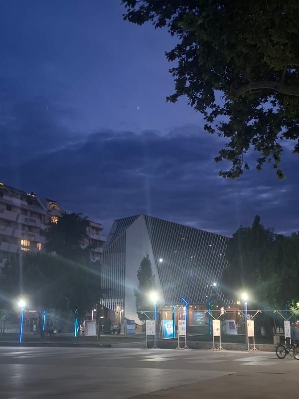 A city evening: streets, monuments, and a dimly lit cafe